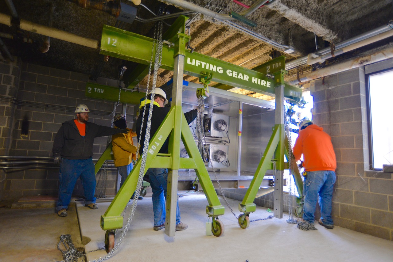 An LGH gantry rental lifting and positioning an HVAC system