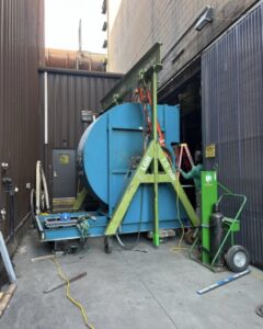 A steel gantry rental from LGH lifting a heavy industrial load.