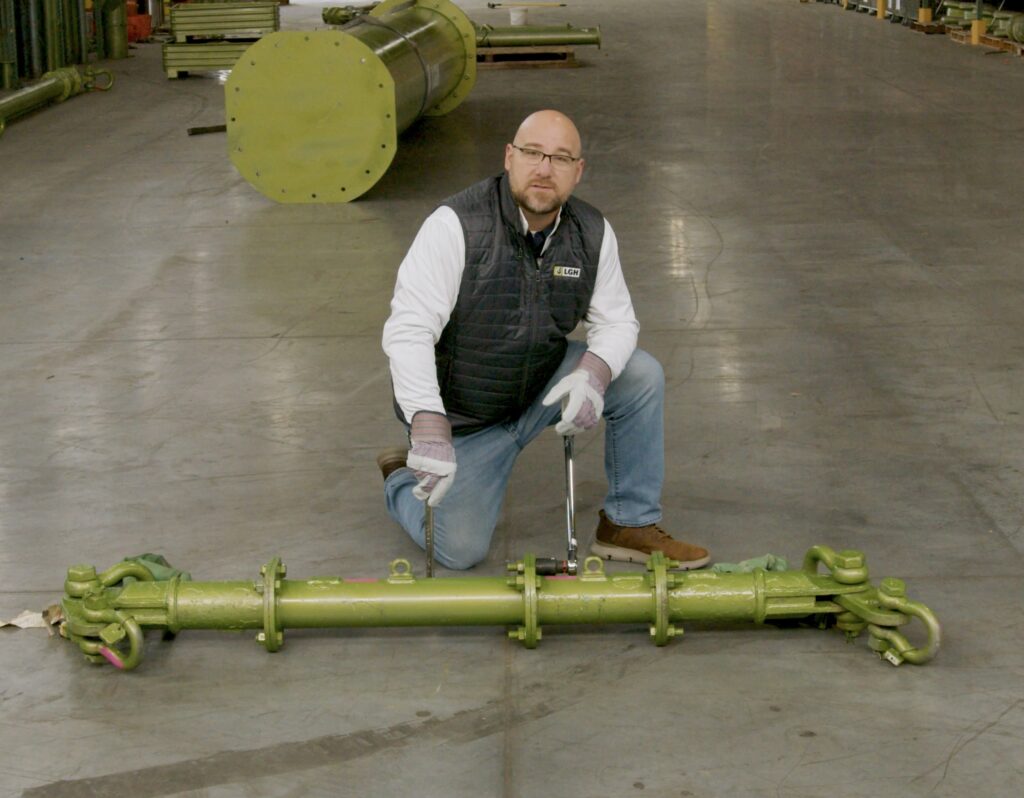 Screenshot of Aaron Orsak from LGH, demonstrating how to use a spreader bar in an educational video from LGH.