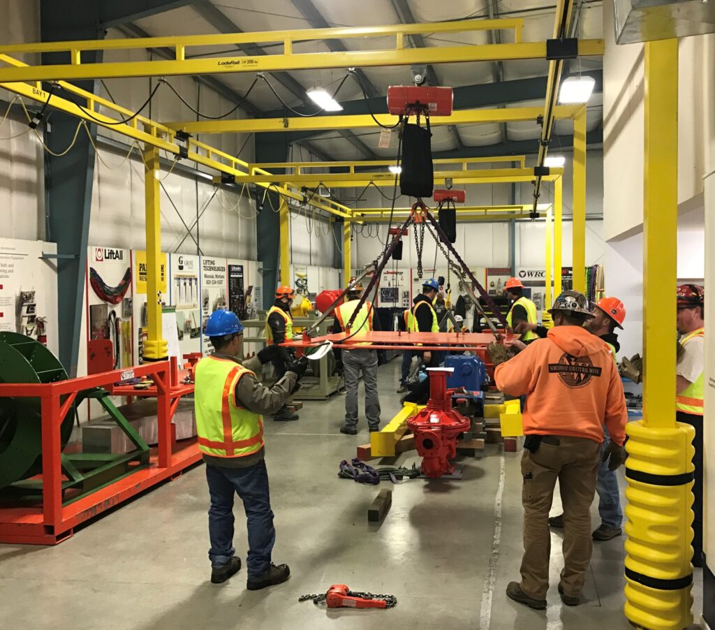 workers dressed in safety gear training during an ITI Masters Riggers rigging certification conference.
