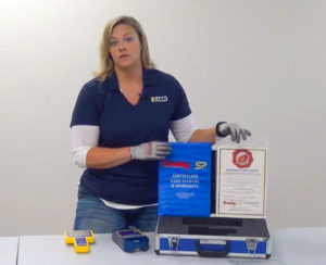 Beth Kolar from LGH and showcasing the calibration and certification paperwork from LGH.