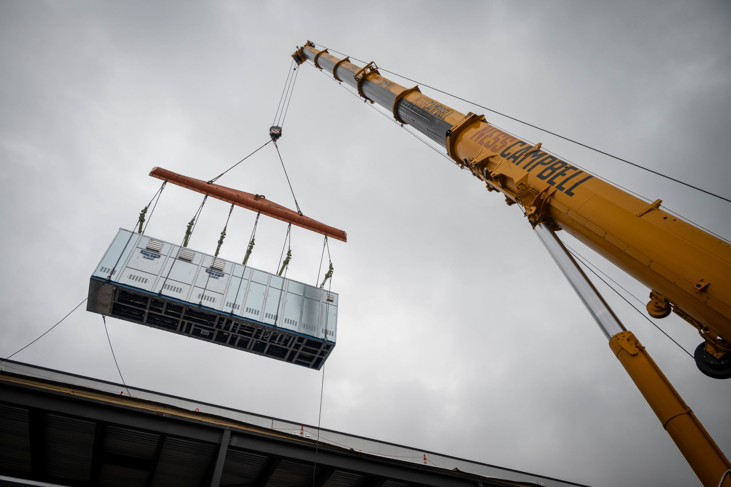 Jobsite picture from LGH and Ness Campbell case study, working on a chiller rack installation in Milwaukie, Oregon.