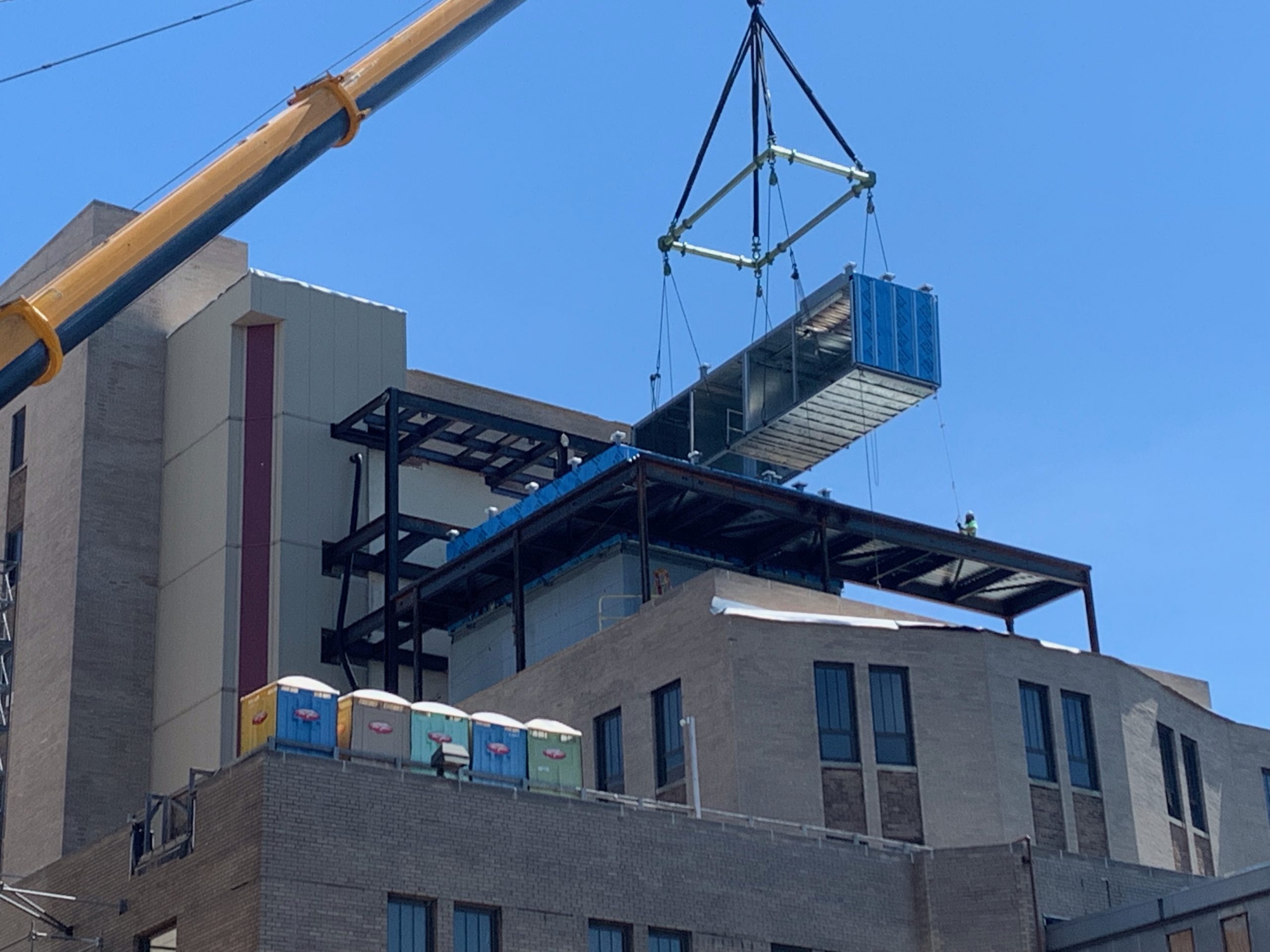 crane and CMOD lifting air handlers in place at Salk Hall