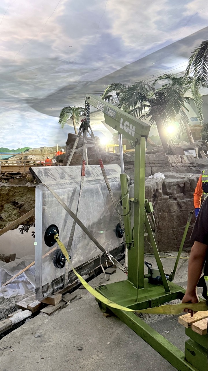 LGH floor crane lifting a glass panel for new shark exhibit at SeaWorld San Diego